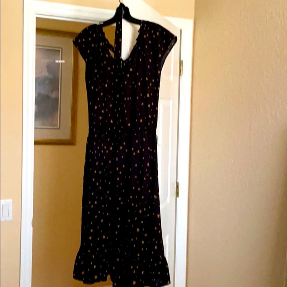 Mid length black dress with gold hearts.